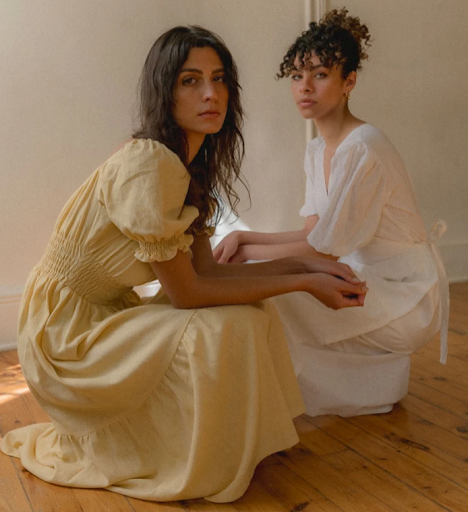 Two women wearing dresses