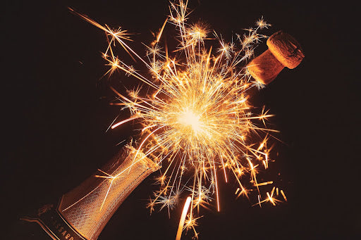 Champagne cork popping off and sparks flying