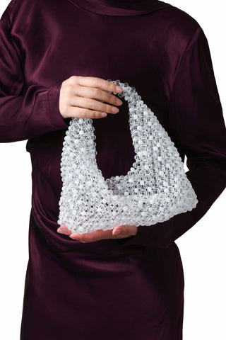 Transparent and white beaded Jodie bag carried by hand