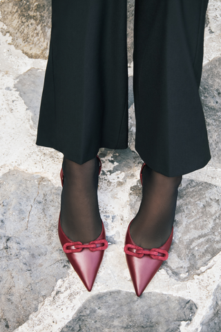 Catena burgundy slingback pump worn with black trousers