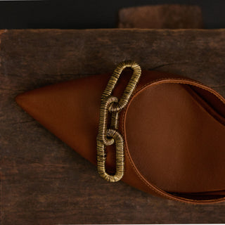 Close-up of the antique gold chain detail on the Catena camello slingback pump