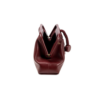 Alessa burgundy leather pouch bag shown open with the magnetic closure