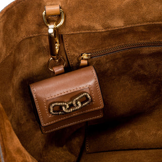 Catena Notte camello AirPods case clipped inside a suede bag